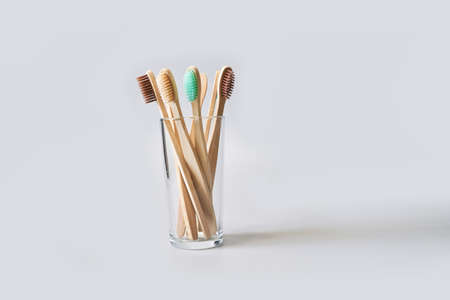 Set of ecology toothbrush on grey background. Different color glass. Diversity concept. Sustainable...