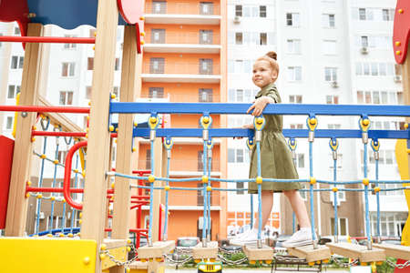 Kid at playground. Pretty face. Cute school child. Active vacation. Small people. Summer freedom. Happy children concept. Lifestyle actionの写真素材
