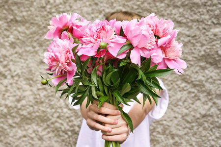 Peony pink bouquet. Female people holding flowers. Faceless lifestyle concept. Summer postcard. Anonymous trend person. Pretty valentine pion. Gorgeous bloomの写真素材