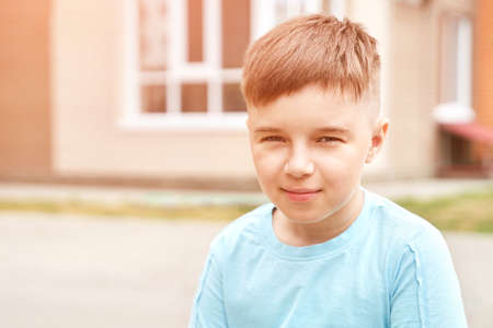 Little boy outdoor portrait. Happy baby face. Male person at backyard. American smart schoolboy. Positive child expression. Smile kid face. Summer timeの写真素材