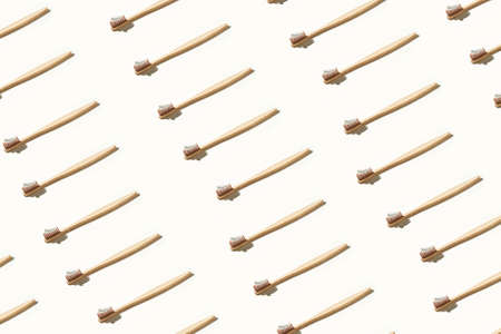 Ecology toothbrush on light background. Same color. Sustainable mouth product. Zero waste lifestyle. Organic accessory group. Dental health at home. Biodegradable recycle patternの写真素材