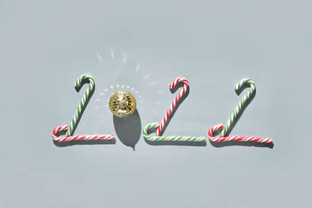 2022 numbers. Happy new Year sign. Start january idea. Creative postcard. Resolution concept. Modern twenty two design. Poster with text. Calendar top view. Candy cane compositionの写真素材