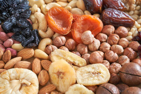 Many different nuts. Assortment healthy snacks. Mediterranean diet. Dry vegan charcuterie. Variety party pile. Kitchen table. Fat nutrientsの写真素材