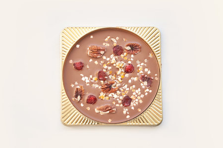 Hand made swiss milk chocolate. Christmas brown textured bar. Top view. Pecan, cranberry, nuts....