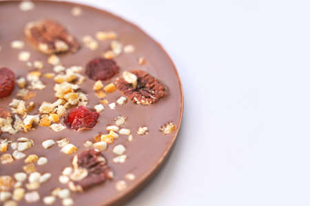 Hand made swiss milk chocolate. Christmas brown textured bar. Top view. Pecan, cranberry, nuts. Handcrafted dessert. Sweet christmas food. Sugar and cacao candy giftの写真素材