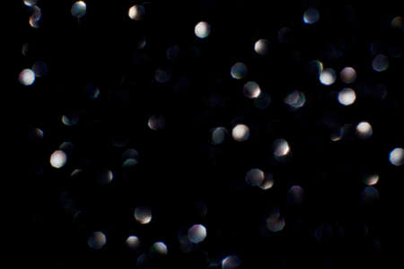 Bokeh circle with silver sparkles background. Grey glitter backdrop. Monochrome texture. New year luxury snow. Copyspace. Shimmer confetti wallpaper. Dreamy shiny design detail. For multiplyの写真素材