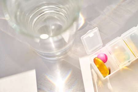 Pregnant woman eat pregnancy pills. Flu supplements. Taking allergy drugs. Medical fish omega 3 food. People body. Drink water. Mother. Sick female person at home. Daily tablet containerの写真素材