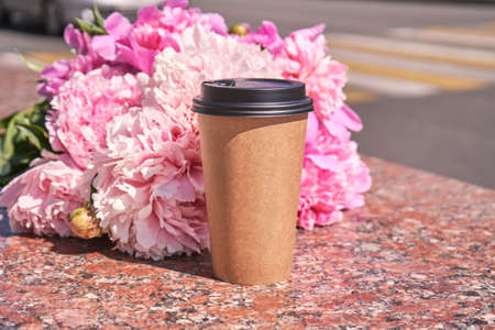 Coffee to go paper cup. Latte mug outdoors. Hot drink container. Americano beverage composition. Marble backgroundの写真素材