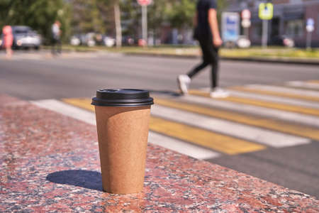 Coffee to go paper cup. Latte mug outdoors. Hot drink container. Americano beverage composition. Marble backgroundの写真素材