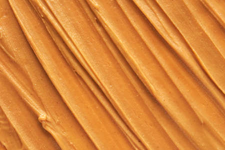 Peanut butter texture. Spread swirl. Organic keto food. Healthy creamy paste. Smooth closeup brown desert. Crunchy macro snack. Fat salt breakfastの写真素材