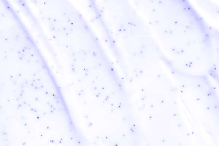 Face scrub texture. Cream skincare cosmetic. Organic stroke. Feet oily cleanser smudge. Particles in gel. White background. Top viewの写真素材