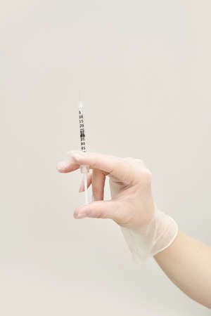 Person in transparent glove hold vaccine with syringe. Injection pharmacy concept. Medical nurse...
