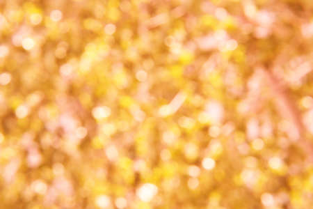 Bokeh circle with gold sparkles background. Yellow glitter backdrop. Golden texture. New year luxury snow. Copyspace. Shimmer confetti wallpaper. Dreamy shiny design detailの写真素材