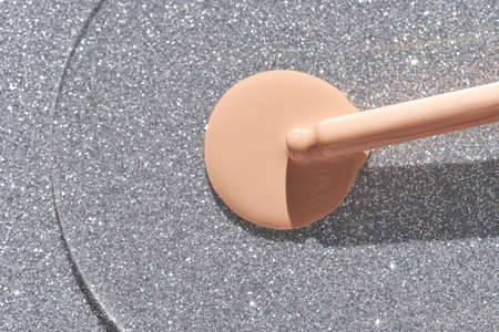 Beige foundation texture swatch. Cream drop with silver sparkles and pipette. Face skincare product. Liquid oil essence. Beauty vitamin collagen splash. Organic body health careの写真素材