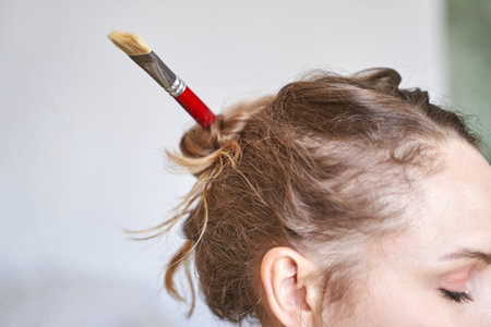 Woman holding paint brush at hand. Watercolor color palette. Art drawing process. Professional education graphic study. Painting hobby class studio. Workshop equipment. Happy businesswomanの写真素材