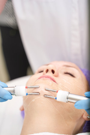 Dermatology anti age treatment. Microcurrent medicine procedure. Woman skin care. Aesthetic peeling...