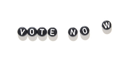 Vote now message with black beads on white background highlighting civic engagement and urgency for public participation.の写真素材