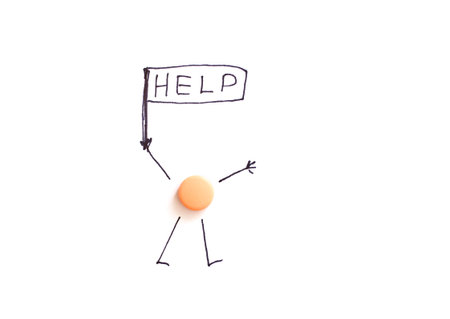 Creative concept featuring a stick figure holding a help sign with a pill body on white background.の写真素材
