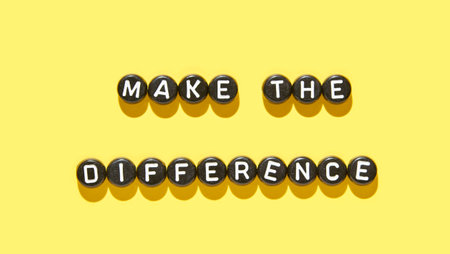Inspirational motivational message with bold typography: make the difference on vibrant yellow background.の写真素材
