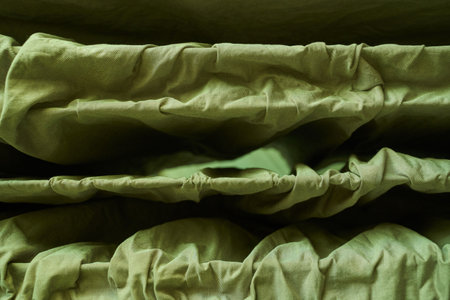 Close up texture of green ruched fabric with natural folds and layers.の写真素材