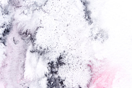 Abstract snowy landscape with textured white and gray watercolor splashes and subtle pink accents.の写真素材