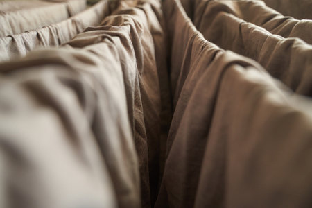 Close up of brown fabric folds creating abstract pattern with soft lighting.の写真素材