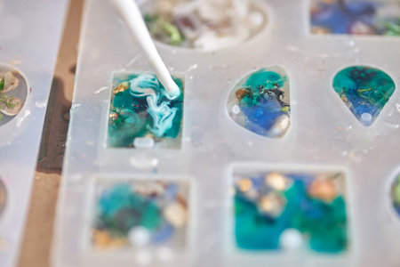 Crafting resin art: creating colorful ocean inspired jewelry with silicone molds and epoxy techniques.の写真素材