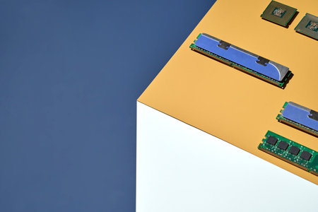 Modern computer components displayed on geometric background with ram and microchips.の写真素材