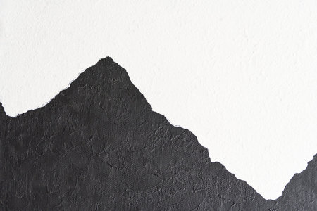 Black and white textured abstract art with mountain silhouette on canvas.の写真素材