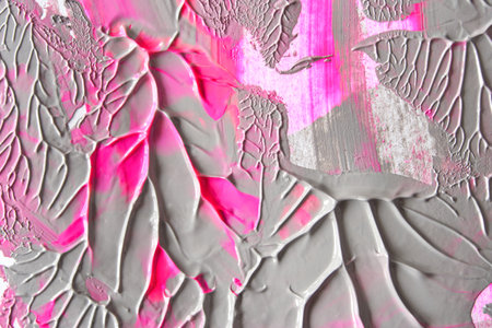 Abstract textured artwork with pink and gray paint layers creating a dynamic pattern.の写真素材