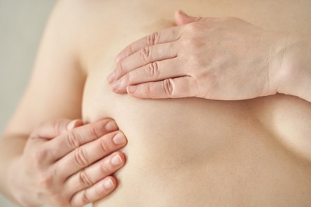 Asian female adult self-examining breast health awareness prevention care.の写真素材