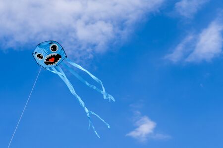 smiling kite flying in the blue skyの写真素材
