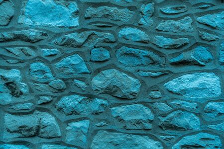 Blue Colorful stone wall Grunge urban backdrop. Dirty old surface. Natural background. Stone texture. High quality photoの写真素材