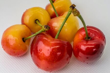 Cherry on a white background. Red and yellow berry closeup macro. Blurred background. Organic fruit. Fresh fruit.の写真素材