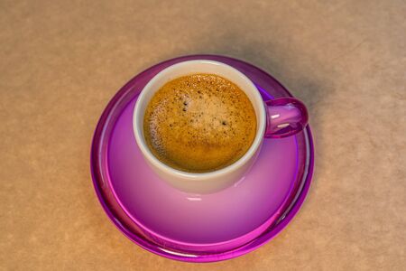 Black cup coffee on beige background. Roasted coffee background, top view.の写真素材