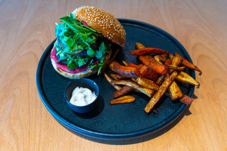 Vegetarian healthy hamburger with cream sous and french fried potatoes. Vegan salad. Healthy lifestyle. Organic healthy food. High quality photoの写真素材