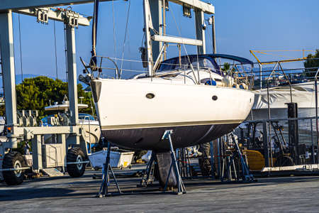Yacht in the dry dock. Maintenance boat service on the mediterranean coast. Hight quality photo