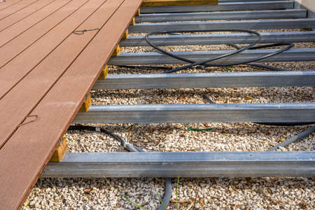Construction of a wooden terrace on a balcony. A new wooden, timber deck being constructed. City...