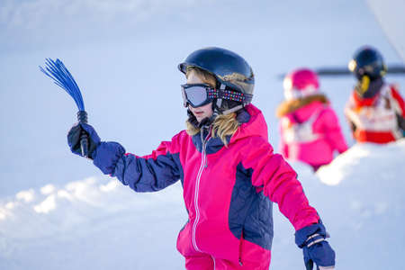 Little girl is learning to ski in ski resort. Winter season.の写真素材