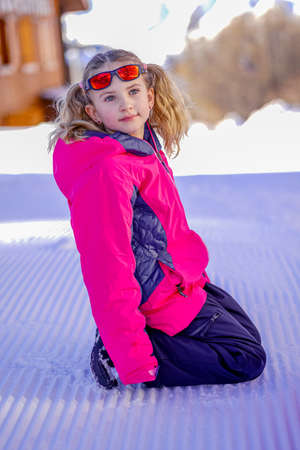Soft focus background. Outdoor winter portrait of little cute girl wearing ski clothes. Stylish clothes for kids.の写真素材