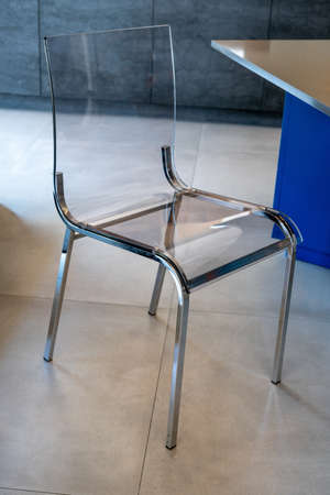 A designed transparent chairs on the show room. High quality photoの写真素材