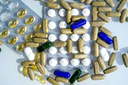 Close-up of different pills and capsules are on the table from virus. Selective focus. Assorted...