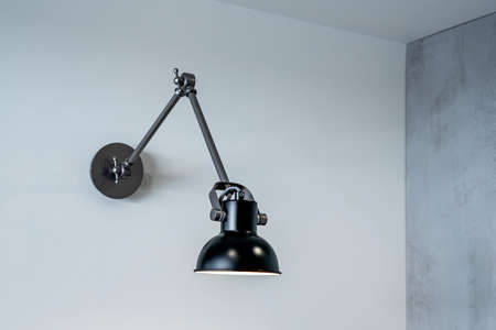 The modern lamp on a wall. Illuminate on the wall background. High quality photoの写真素材