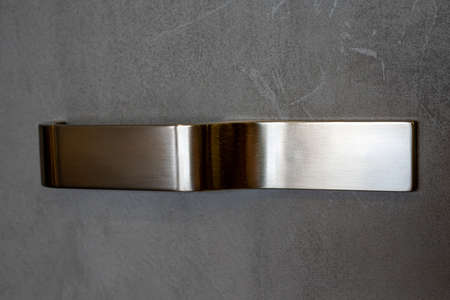 Conceptual photo of the doors of a modern gray wardrobe with chrome handle. High quality photoの写真素材