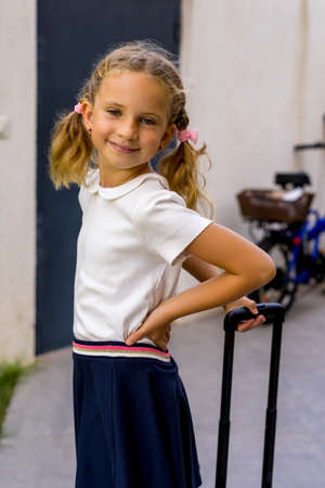 Portrait of happy caucasian young girl going to school. Closeup face of smiling schoolgirl looking at camera.の写真素材