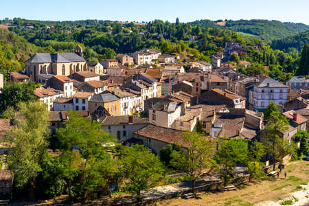 Beautiful top view of the French village of Laguepie. Old catholic cathedral. Orange tiled roofs.の写真素材
