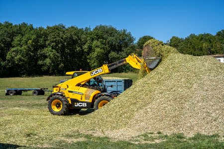 Laguepie, France 25.08.2020 Preparing sorghum silage for cattle feeding. Rural background