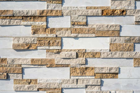 Stone wall brick texture background beige and white surface facade. Close - up. Hight quality photo