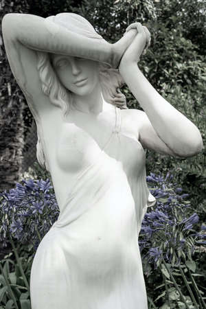 Garden sculpture depicts the figure of a beautiful young woman.の写真素材
