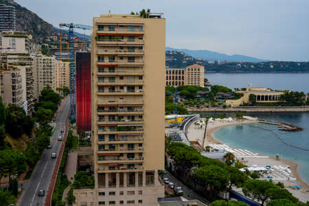 Monte-Carlo, Monaco. 09.10.2020 Building construction on the coast of Monaco. View from above. Buildings and hills on the background.のeditorial素材